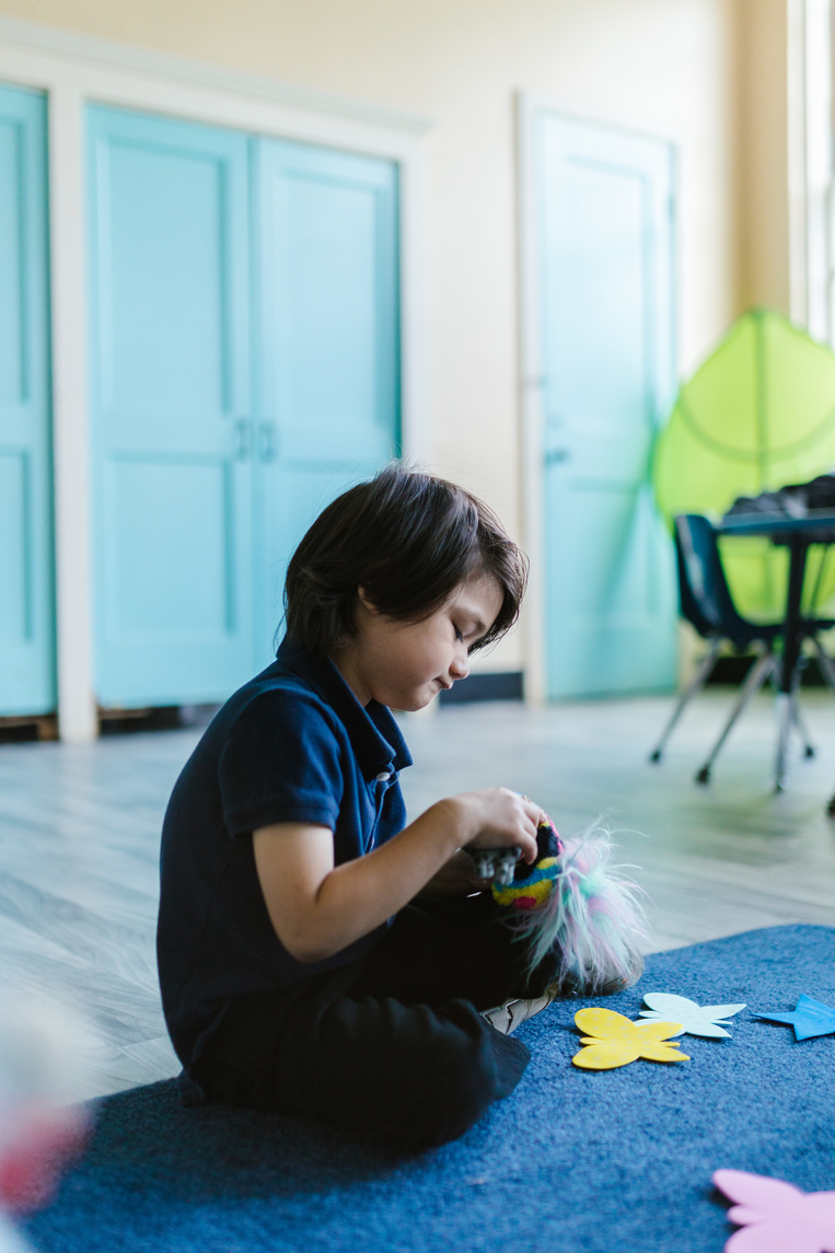 A Kid Playing Inside the Classroom